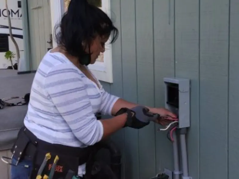 Licensed electrician wiring an exterior subpanel in Fairfield